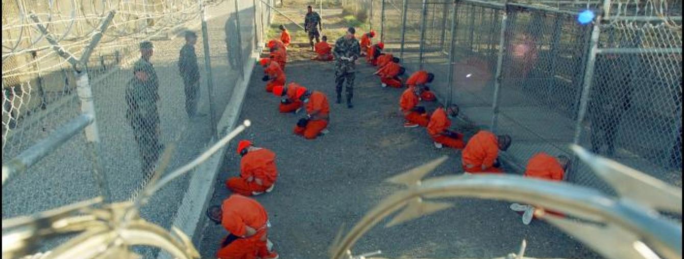 Guantanamo captives wait during processing on January 11th 2002