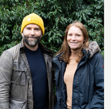 Two people, John and Emma, smiling at camera