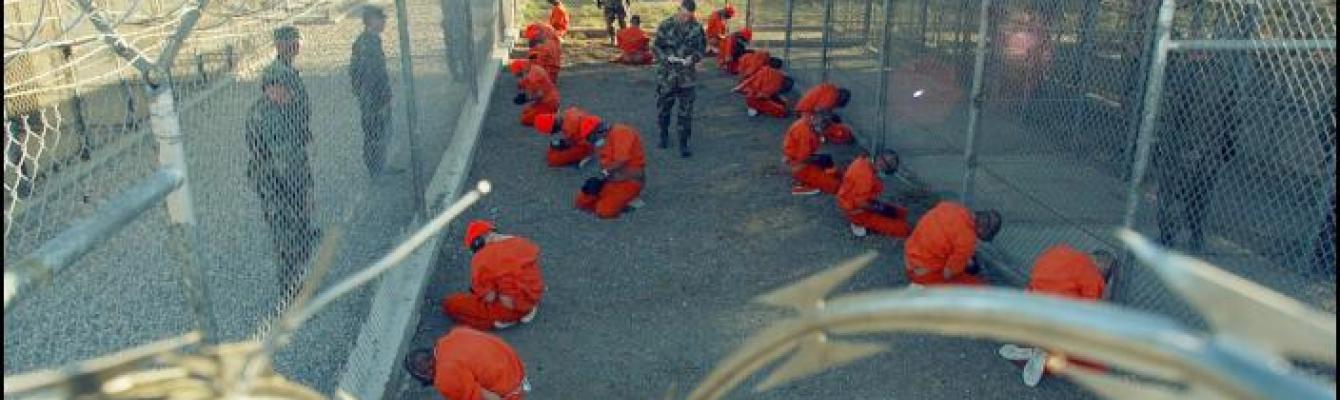 Guantanamo captives wait during processing on January 11th 2002