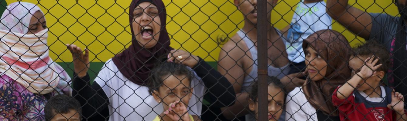 Syrian women and children refugees striking at the platform of a budapest railway station