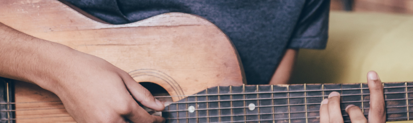 Young man from eastern Africa playing guitar 