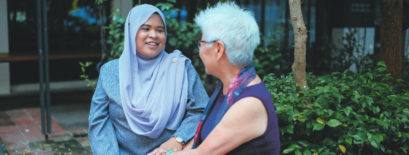 Muslim woman talking to older woman