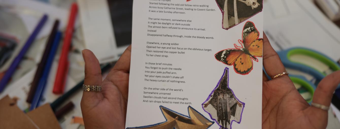 Person holding a zine showing a poem