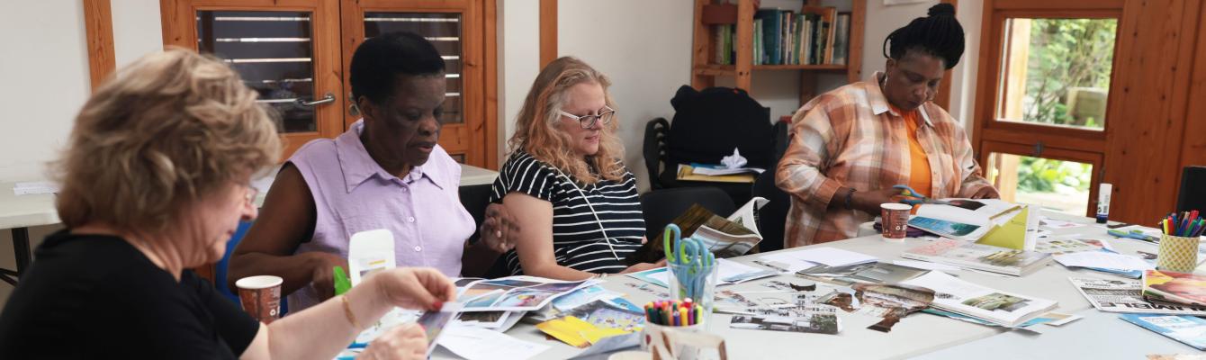 Group of people making artwork around a table