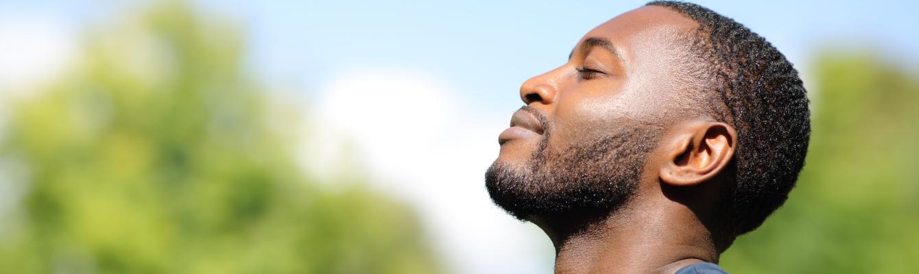 Side profile of man looking up at the sky