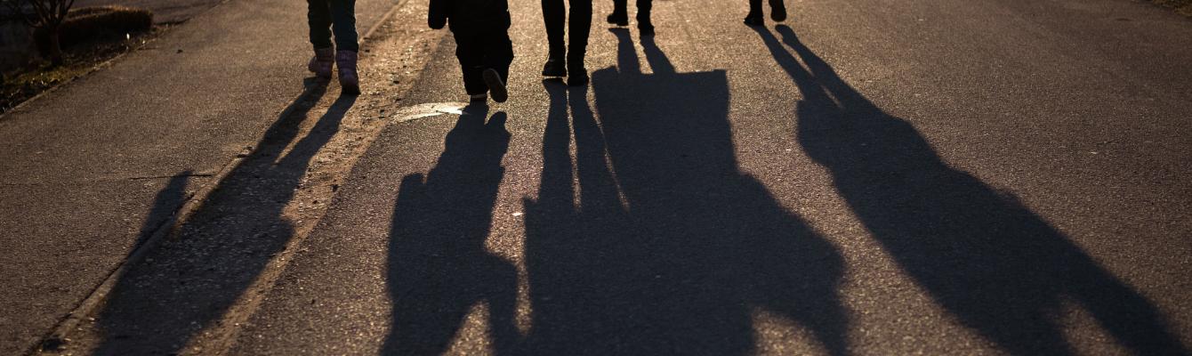 Shadows of a family on a street