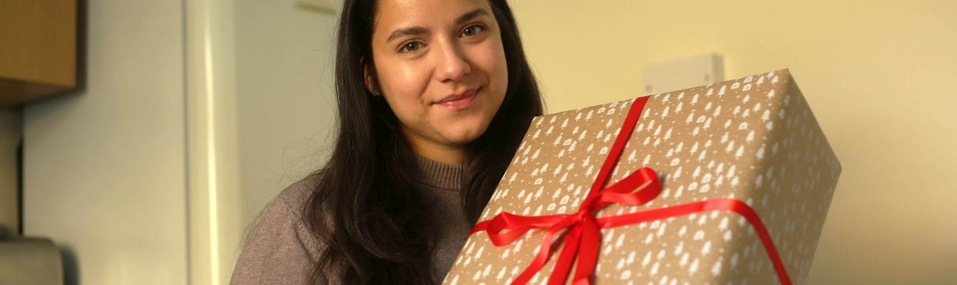 Young girl holding Christmas present