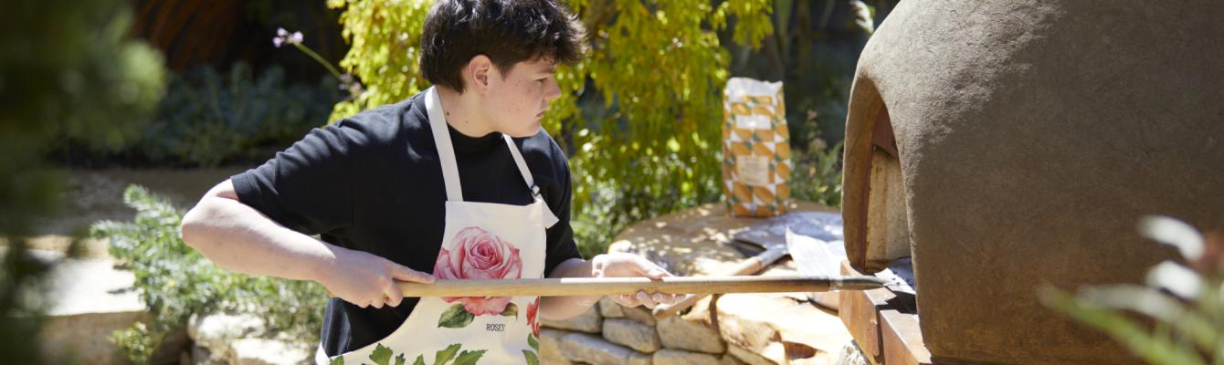 Young person using a bread oven