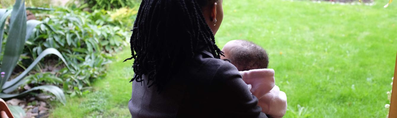 Woman and child looking out to a garden.