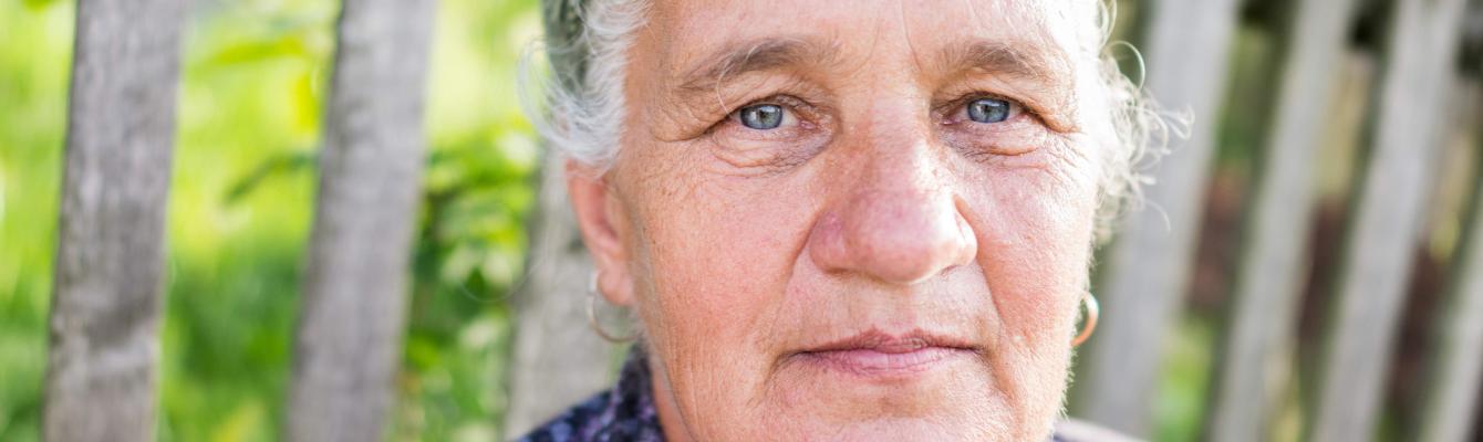 Older Eastern European woman looking into camera