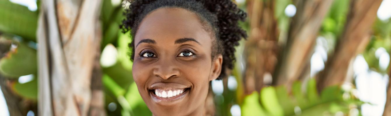 Middle aged Black woman smiling at camera