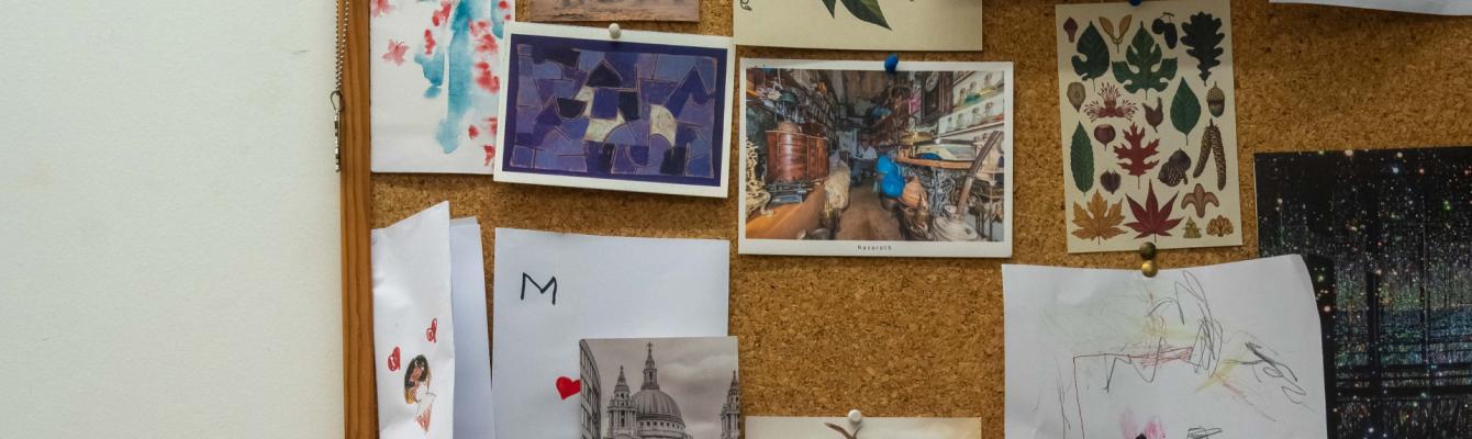 Board displaying postcards in therapist office