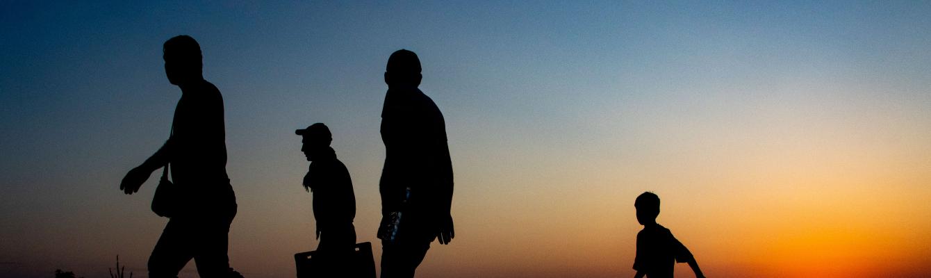 Silhoutte of a group of people walking