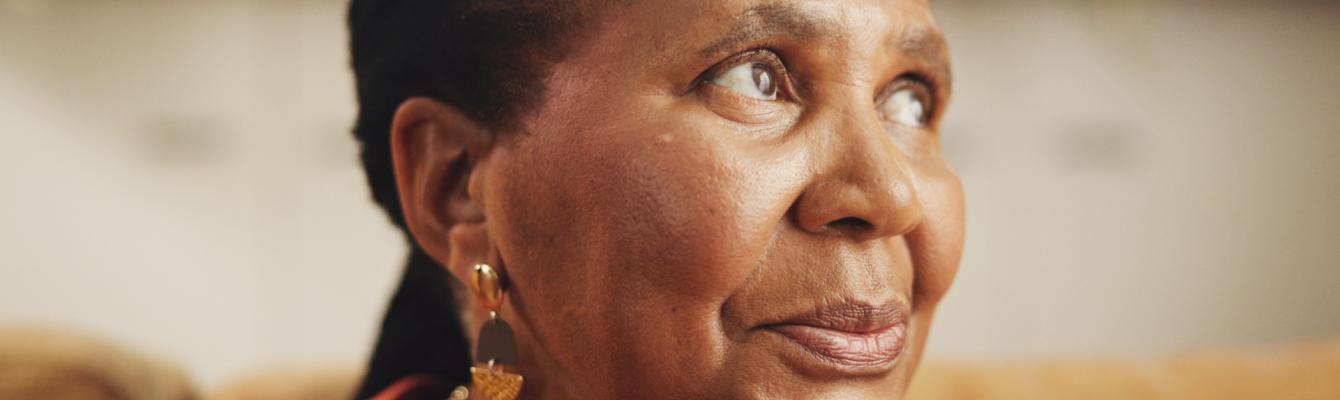 Older black woman looking to the side of the camera