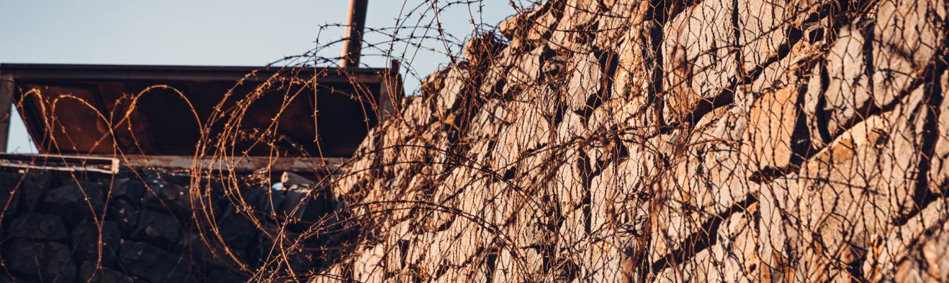 Barbed wire and wall