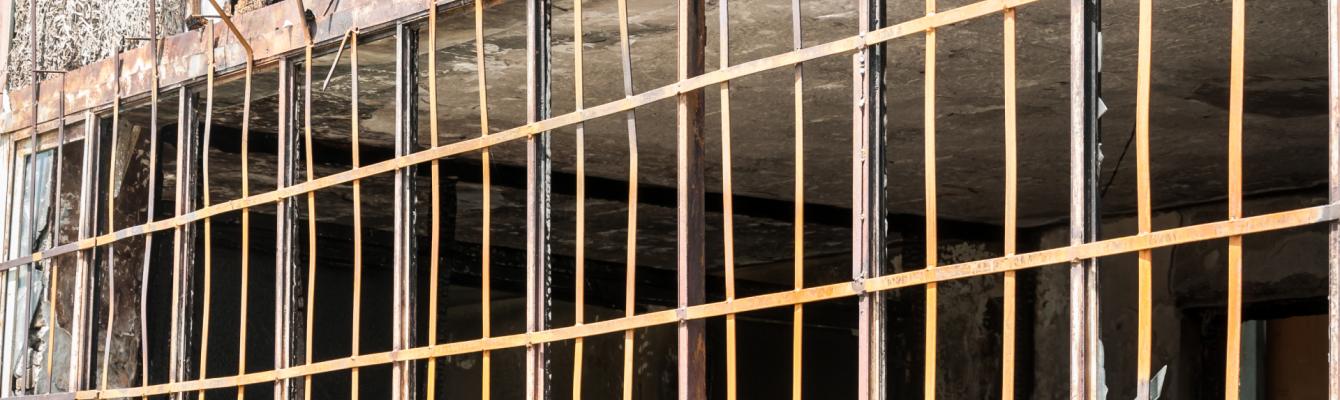 Close up of metal safety bars on the windows of a prison