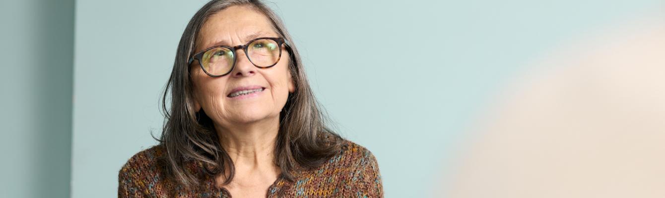 Older woman smiling to side of camera