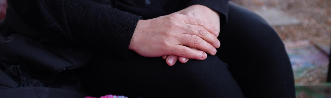 An older woman's hands cusped together