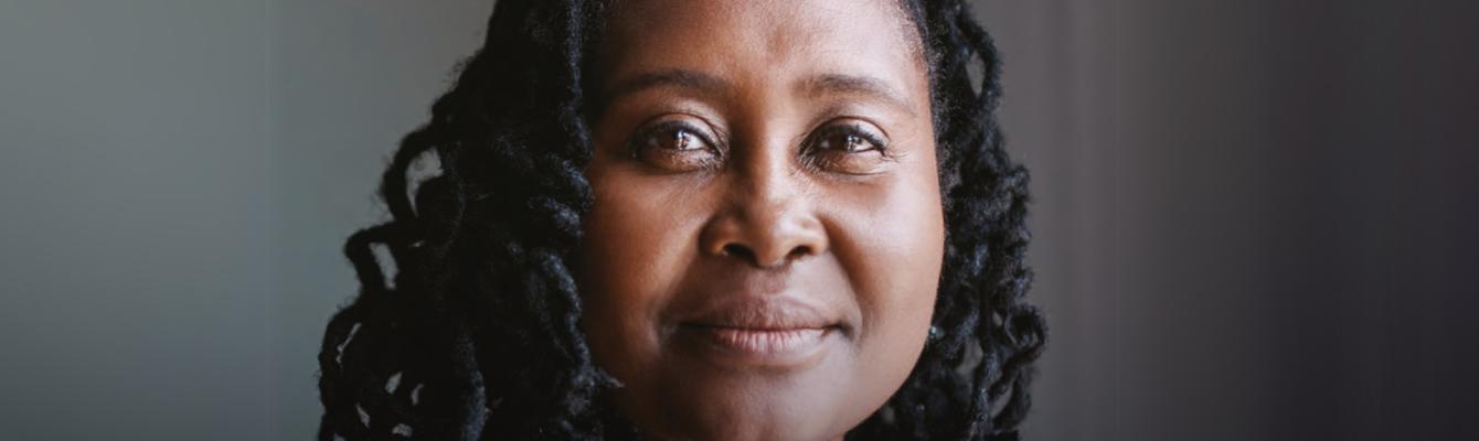 Black middle aged woman smiles at the camera