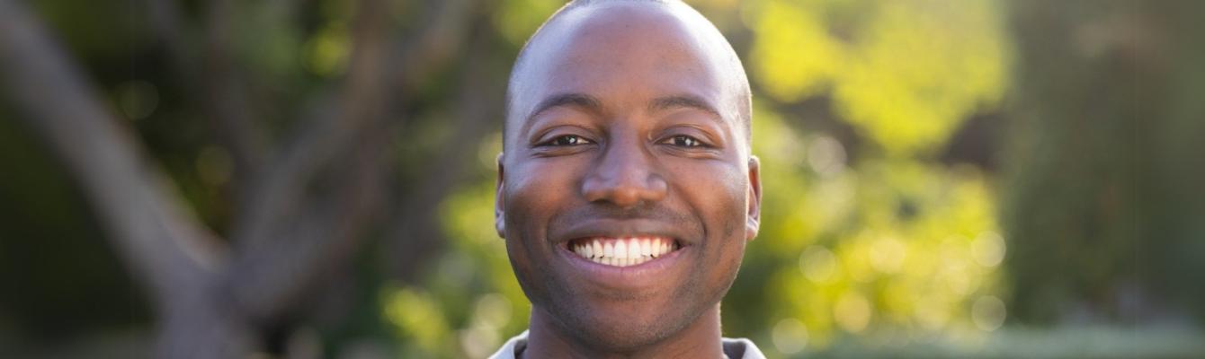 Young black man smiling at the camera