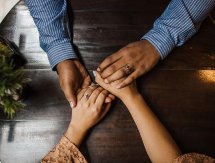 A couple hold hands