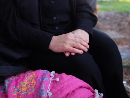 An older woman's hands cusped together