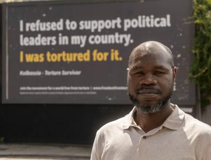 man in front of billboard