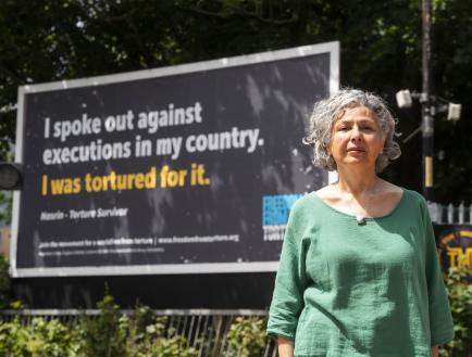women in front of billboard