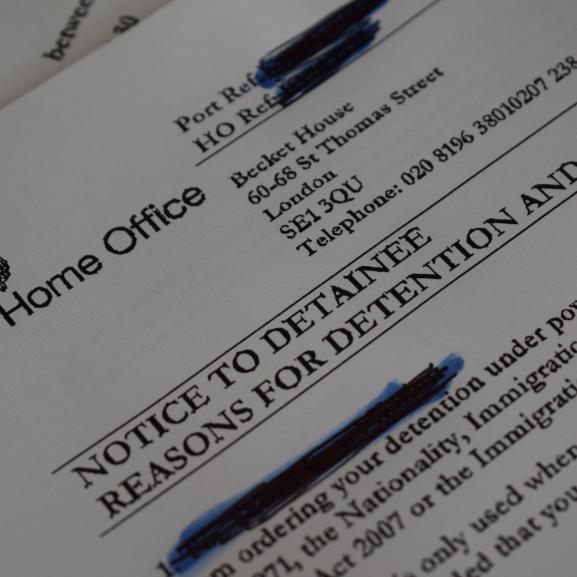 Home Office paperwork showing a decision to detain a person