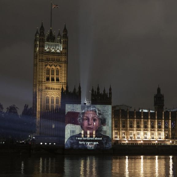 Video of survivor projected onto Houses of Parliament