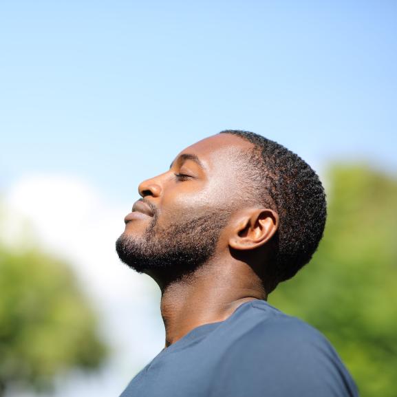 Side profile of man looking up at the sky