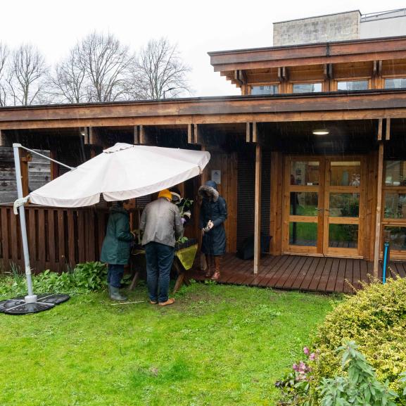 Landscape photo of people in the background of a garden