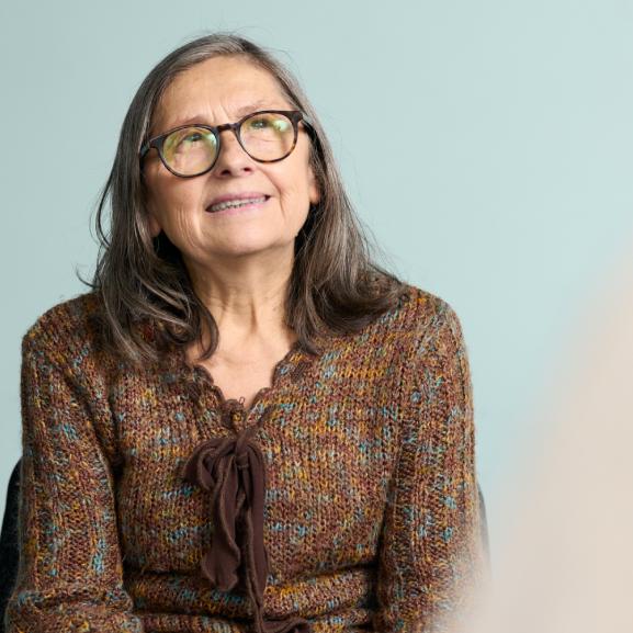 Older woman smiling to side of camera