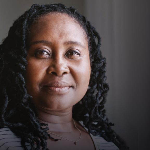 Black middle aged woman smiles at the camera