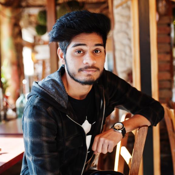 Young Asian man looking into camera