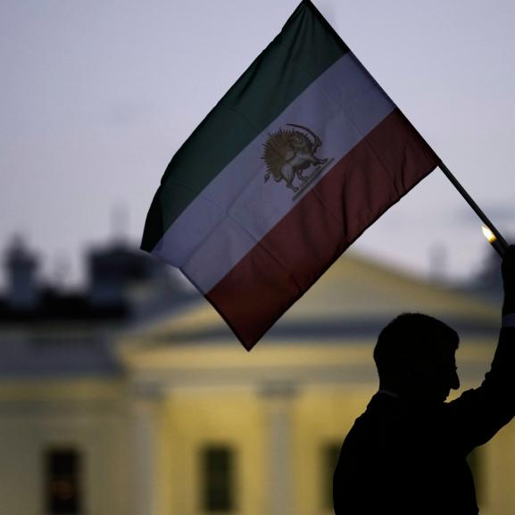 Iranian Lion and Sun flag being held up