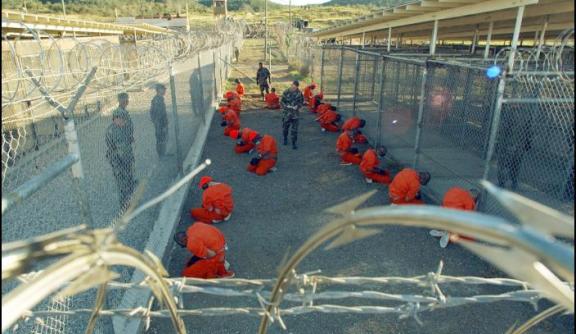 Guantanamo captives wait during processing on January 11th 2002