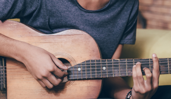 Young man from eastern Africa playing guitar 