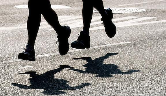two shadows of feet running