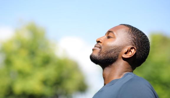 Side profile of man looking up at the sky