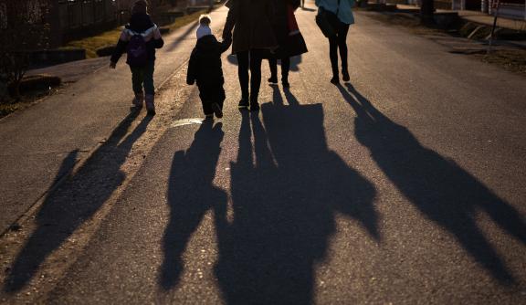 Shadows of a family on a street