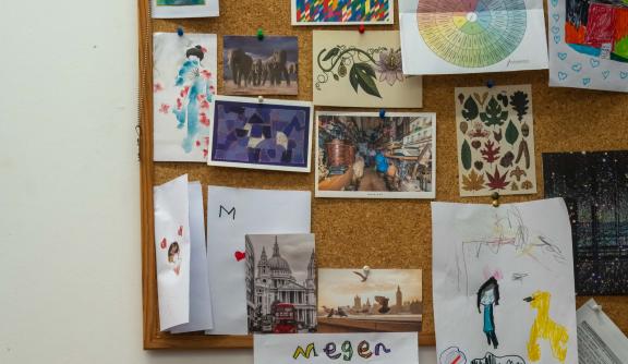Board displaying postcards in therapist office