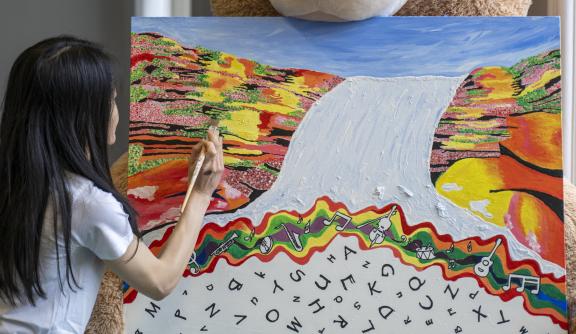 Young woman, back of her head, painting