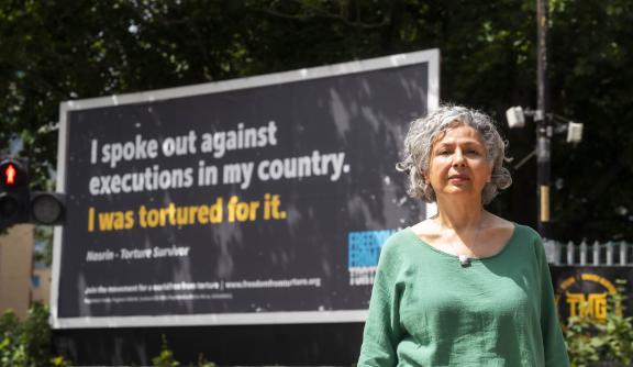 women in front of billboard