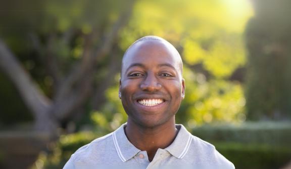 Young black man smiling at the camera