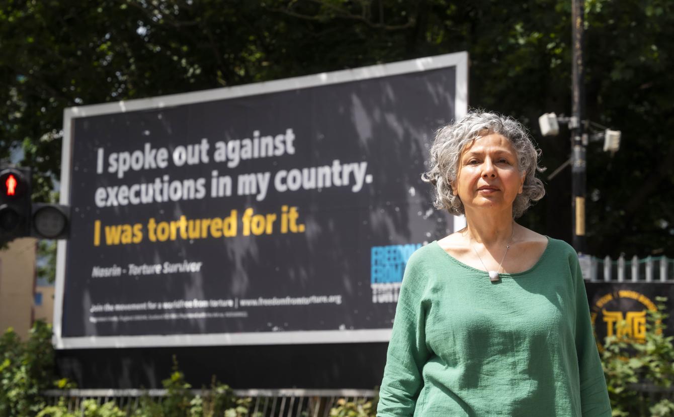 women in front of billboard