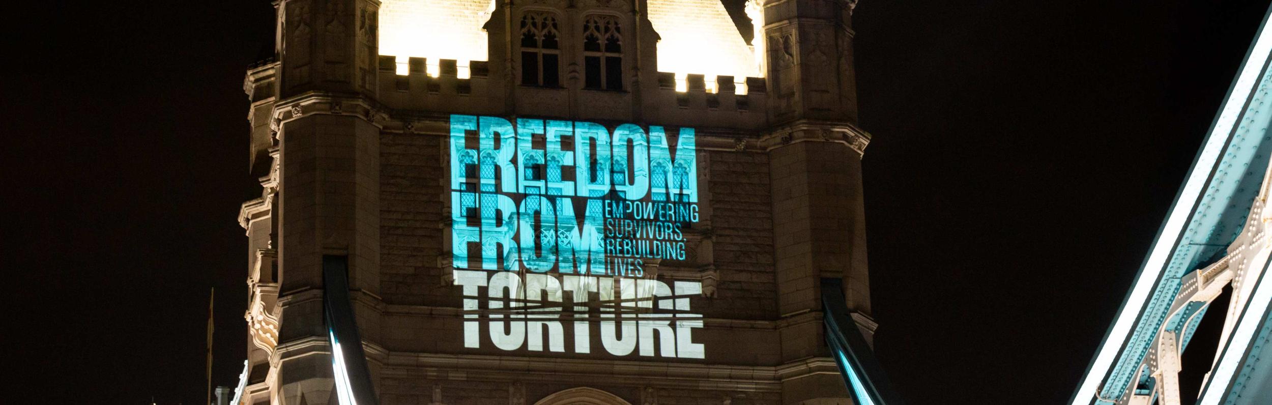 Projection on Tower Bridge with Freedom from Torture logo
